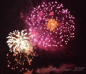 side-by-side colorful fireworks exploding