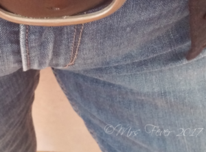 woman's belt buckle and jeans seam