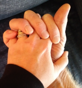 man's and woman's hands entwined