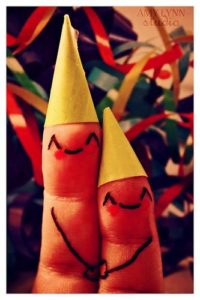 two fingers in party hats