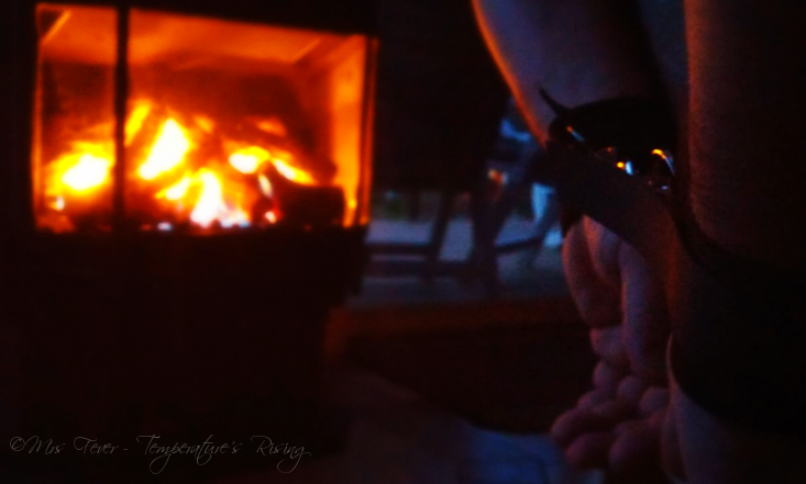 man's hands cuffed near fireplace