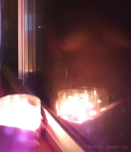 nude reflection in candlelit window with bokeh