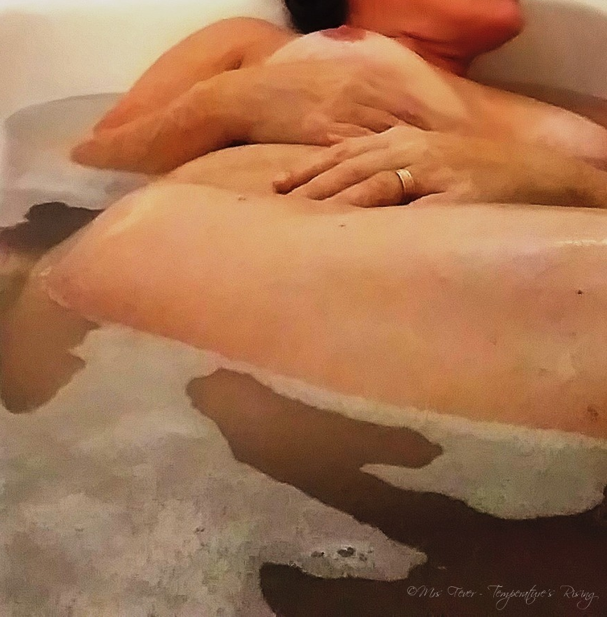 nude woman reclining in bath