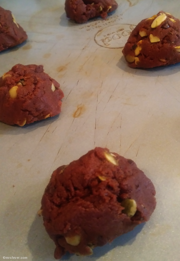 balled raw chocolate chunk cookie dough with pumpkin seeds