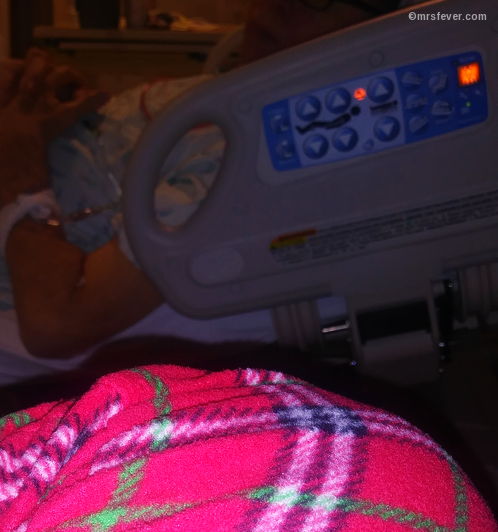 over-the-knee view of hospital bed -- knee clad in plaid jammies