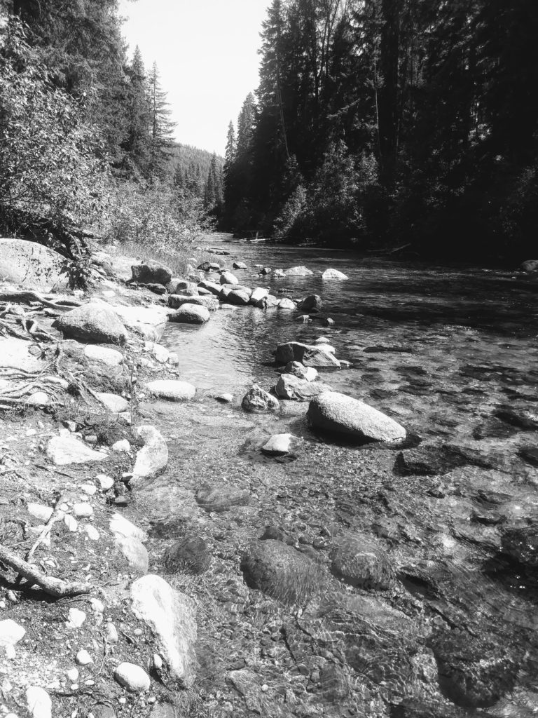 black & white image of alpine water running over rocks