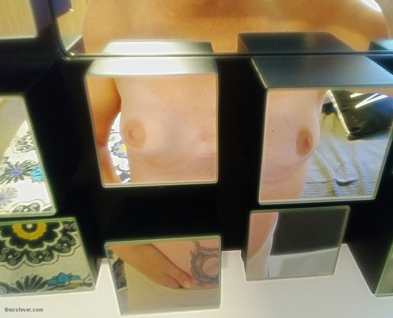 topless woman reflected in five split mirror blocks