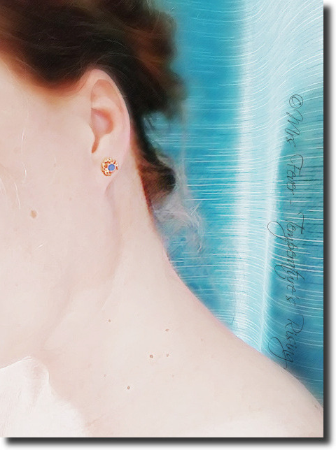 side view of woman's neck and ear, featuring blue and gold crab earring