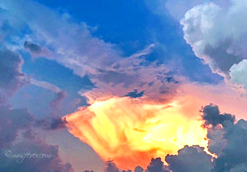 fiery light shining through storm clouds