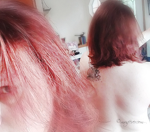 photo of front side and back reflection of nude woman's shortened-by-ten-inches dyed red hair