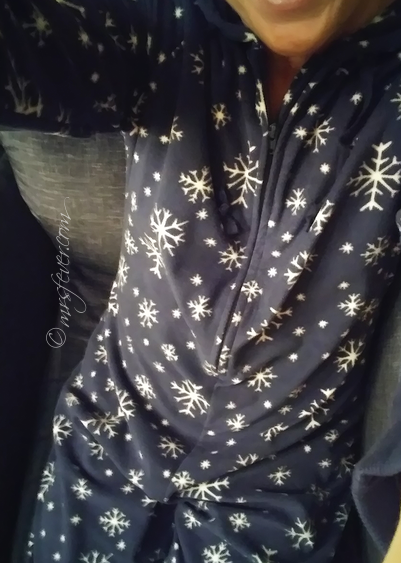 woman wearing dark blue onesie pajamas with snowflake design