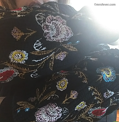 colorful embroidered sleeves on black sweater