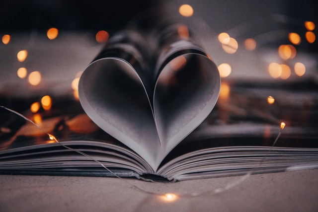 open book with pages shaped into a heart, via Unsplash