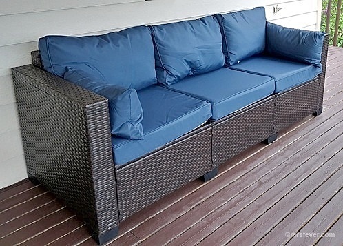 brown wicker deck couch with blue cushions